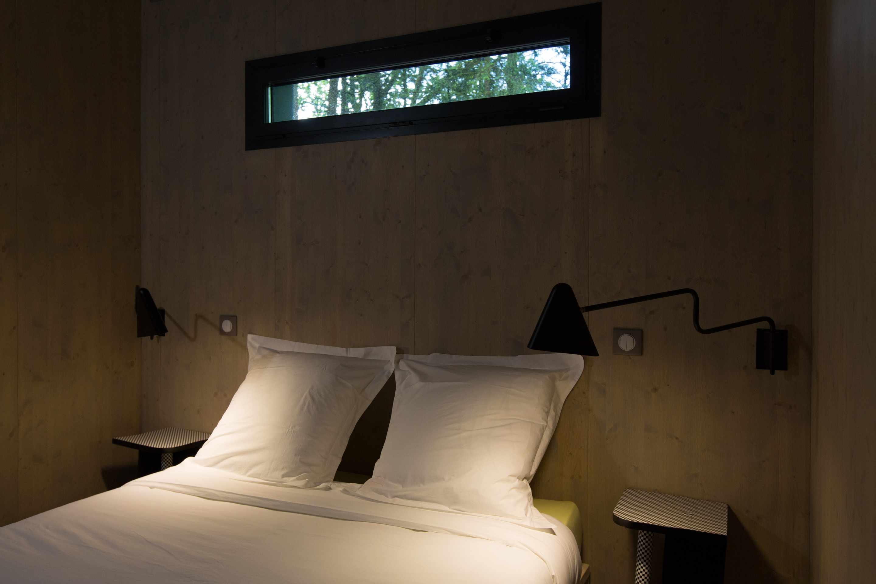 E98A8009 Chambre moderne en bois avec lit double et éclairage design, située en Limousin.