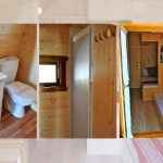 Cabane en bois avec salle de bain, douche et lit confortable. Ambiance chaleureuse.