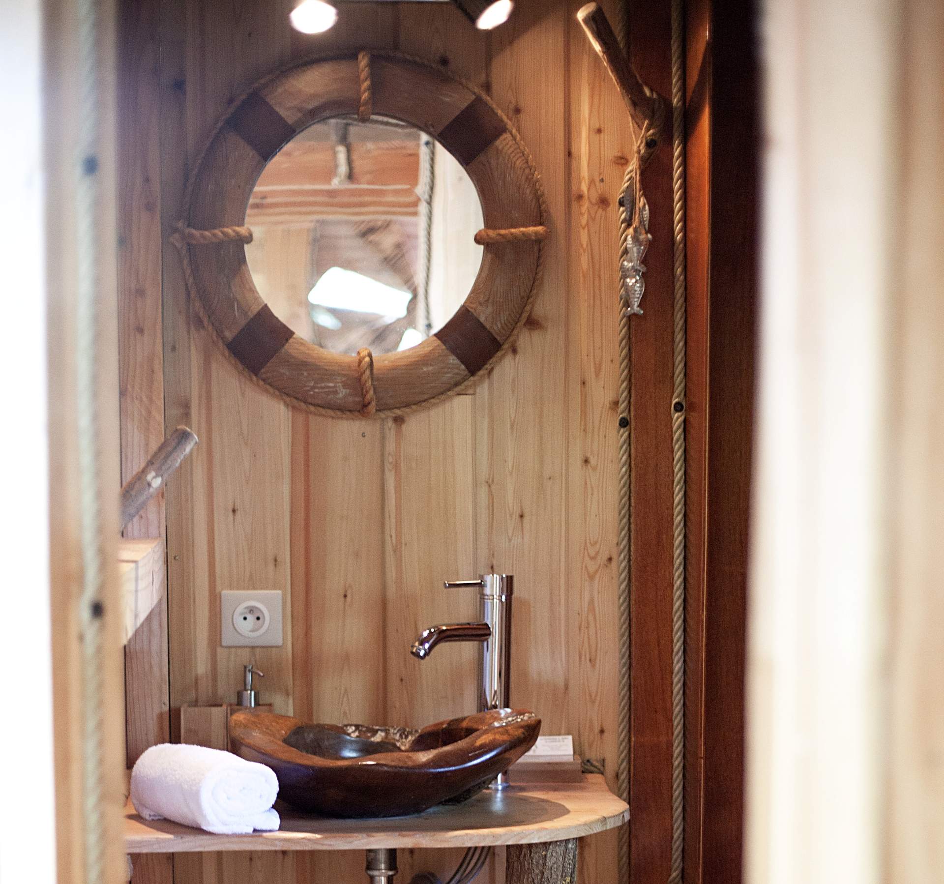 SDB pecheur Salle de bain en bois dans un hébergement insolite, avec un lavabo en pierre.