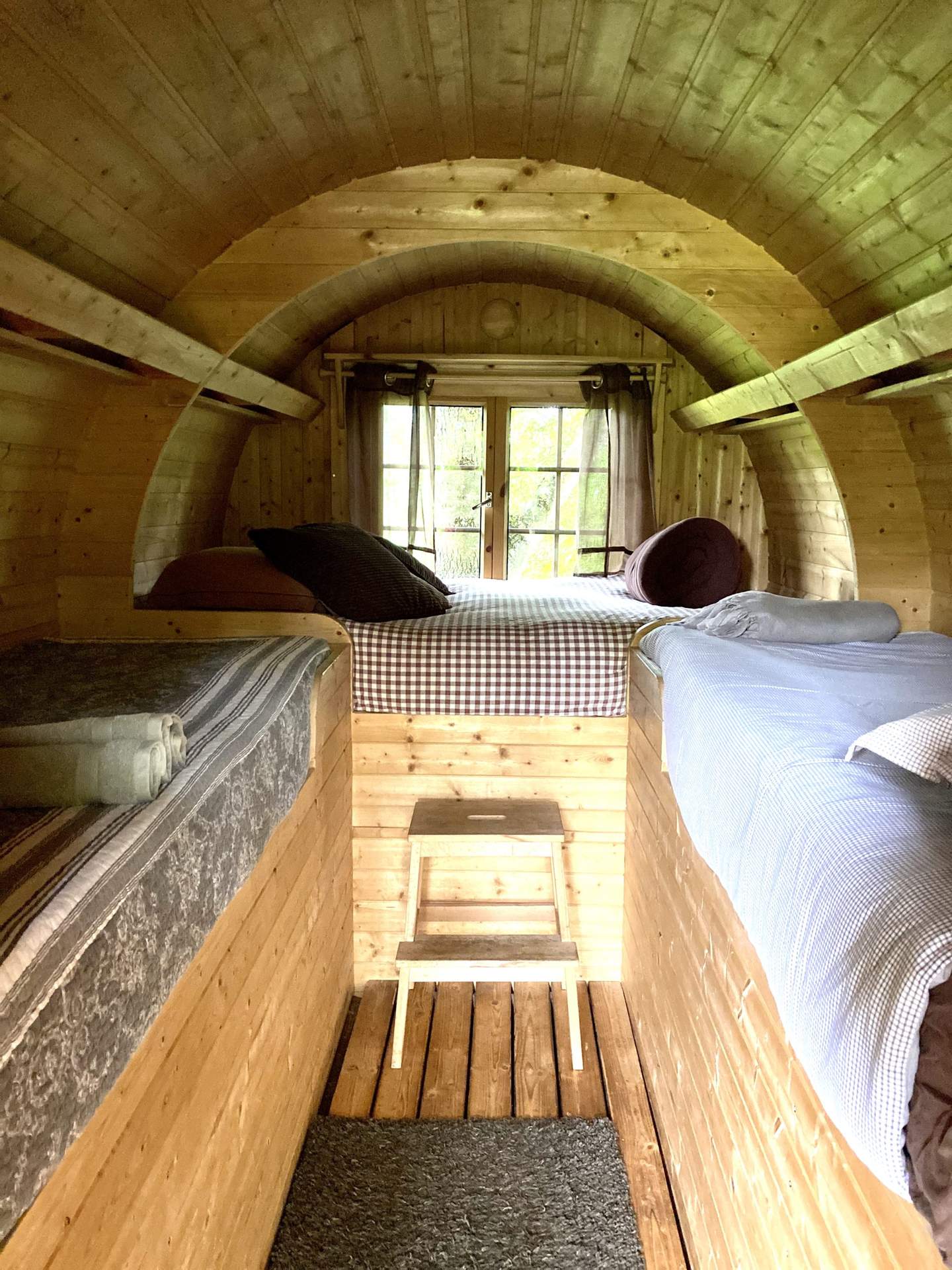 IMG-2327 Hébergement insolite en forme de tonneau, intérieur en bois chaleureux avec lits confortables.