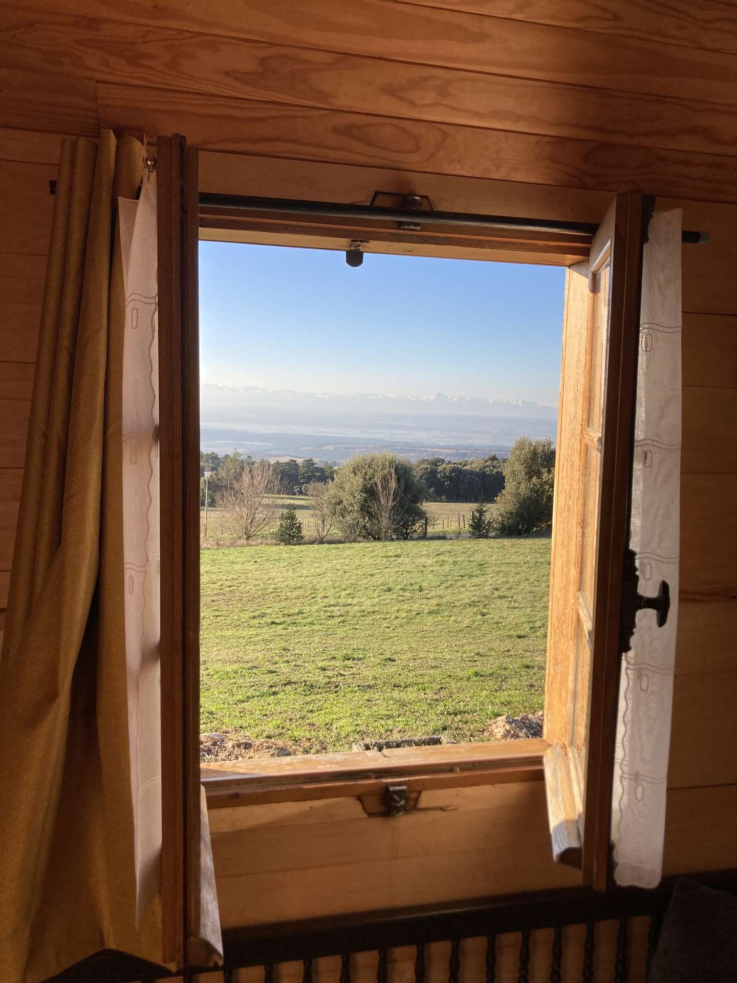 IMG_1556 Vue panoramique depuis un chalet en bois, entouré de verdure à Languedoc-Roussillon.