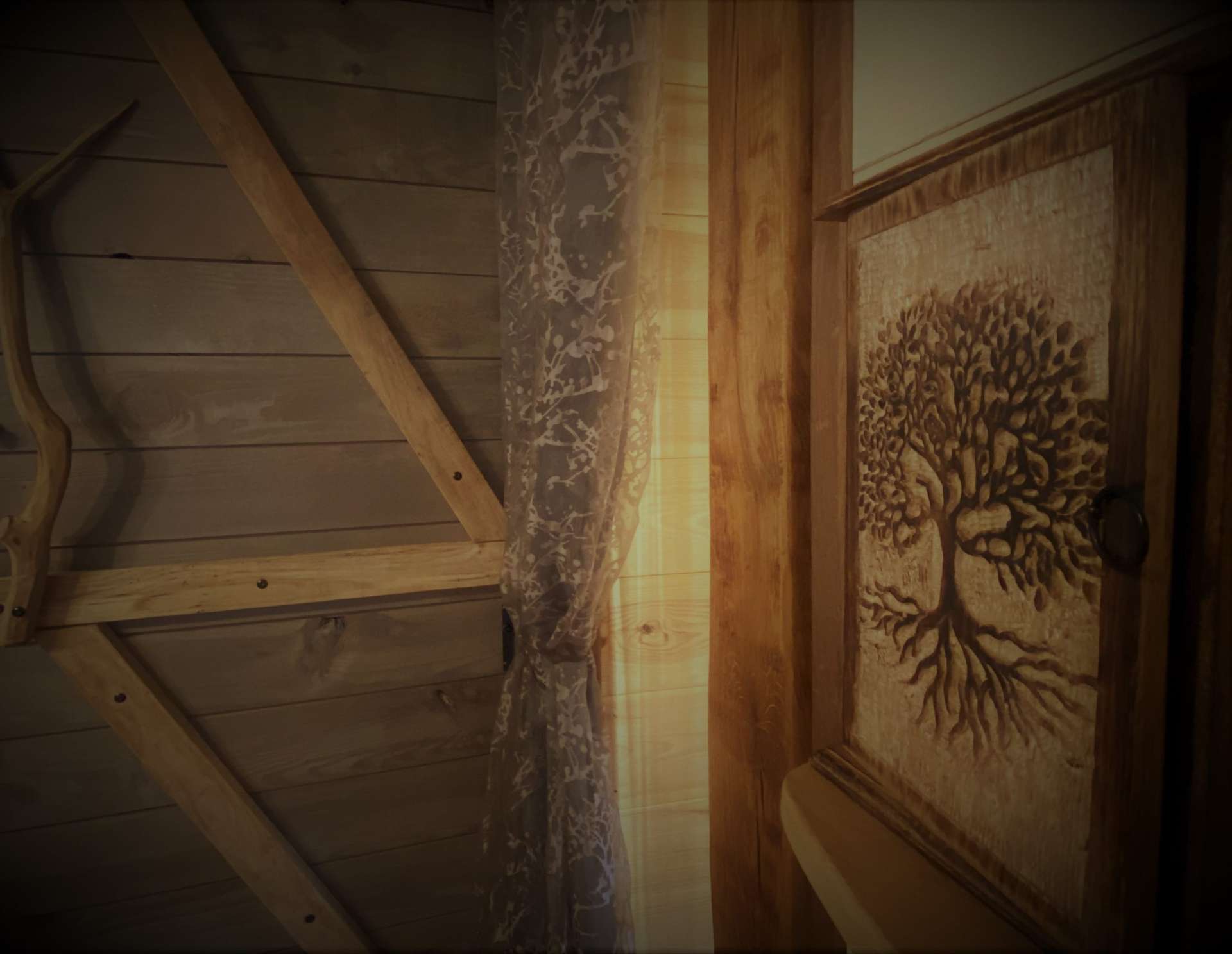 IMG_5714 Hébergement insolite en Midi-Pyrénées, intérieur en bois avec un motif darbre sculpté.