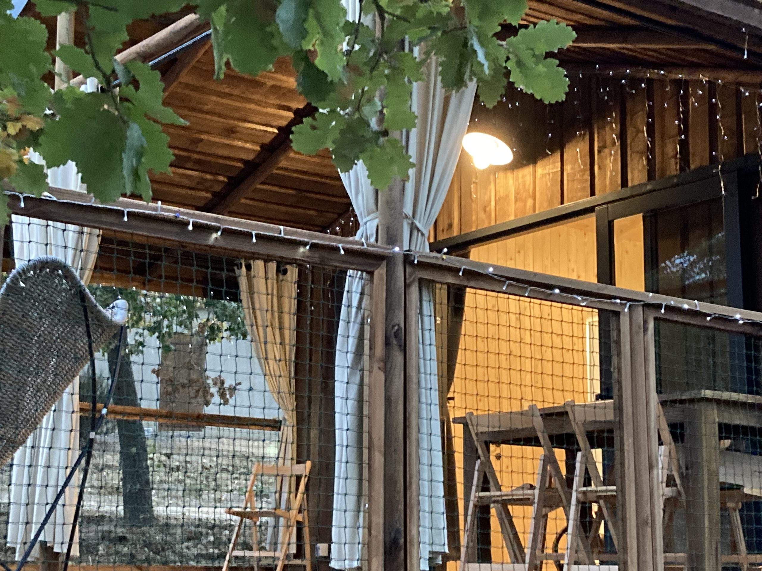 IMG_1433 Cabane en bois avec rideaux blancs et éclairage doux, au cœur du Languedoc-Roussillon.