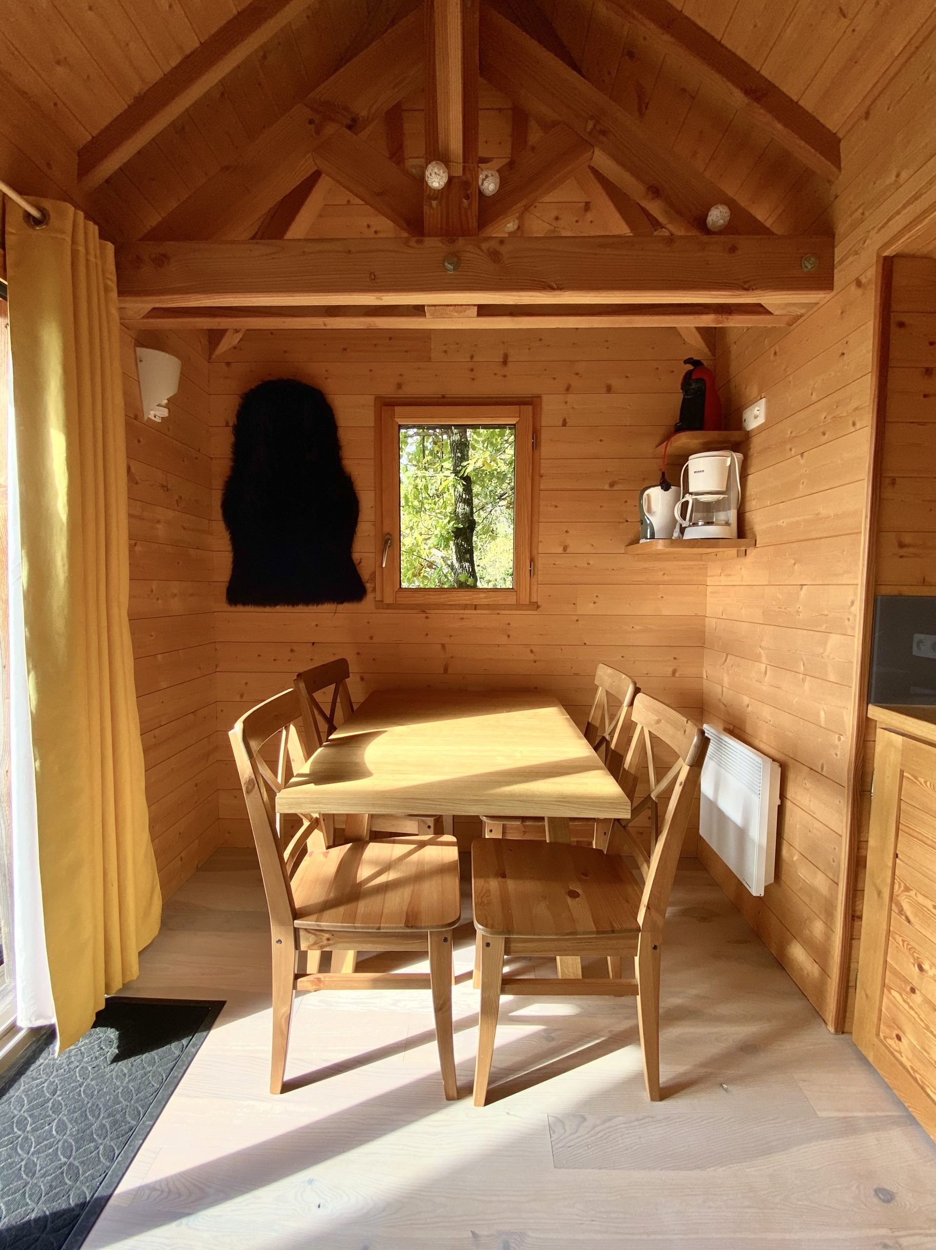 image00009-scaled Cabane en bois chaleureuse avec une table en bois et des murs en lambris.