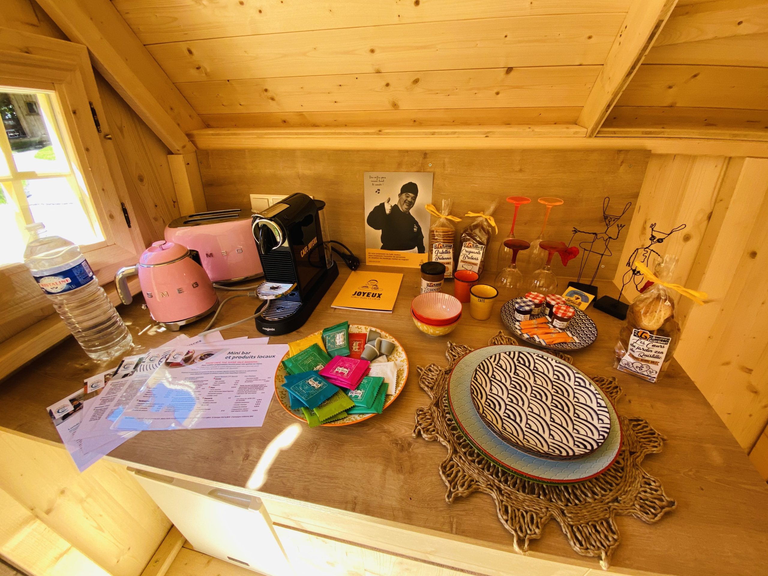 IMG_7777 Hébergement insolite en Bretagne : un chalet en bois avec un coin café coloré.
