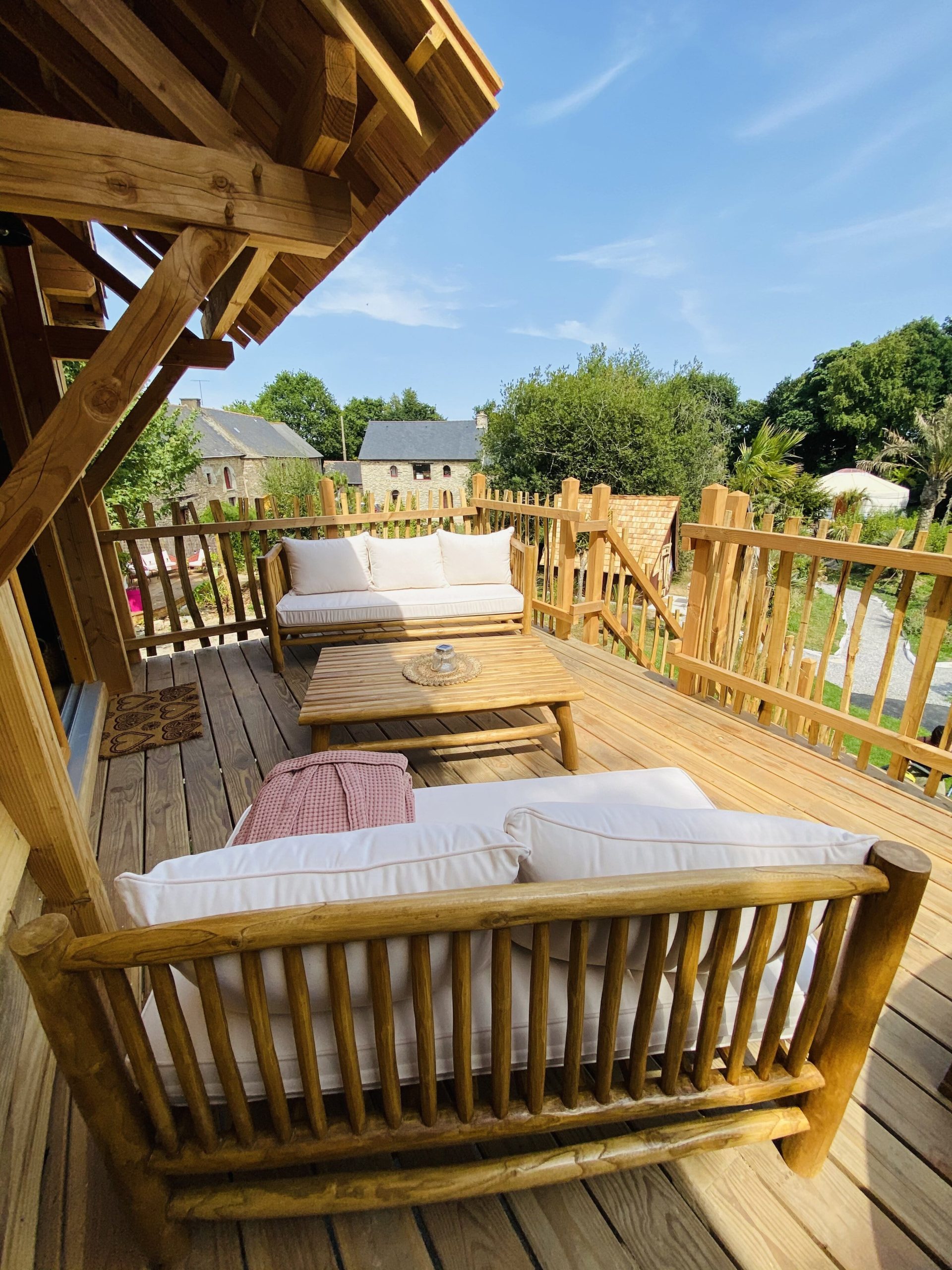 IMG_7923 Cabane en bois en Bretagne avec terrasse ensoleillée et mobilier confortable.
