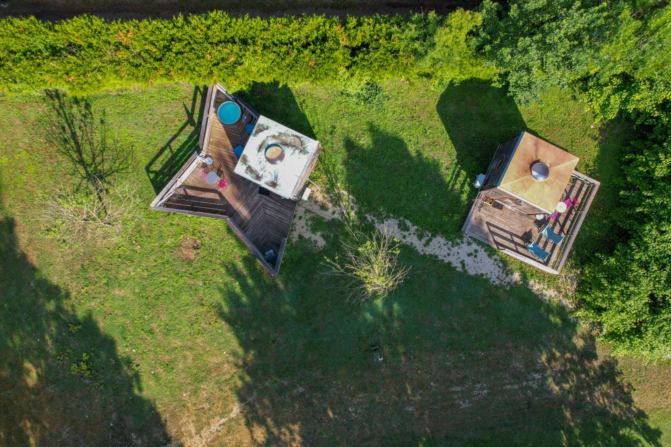 J5_6Champagne-236 Hébergement insolite en cabanes avec terrasses en bois, entourées de verdure.