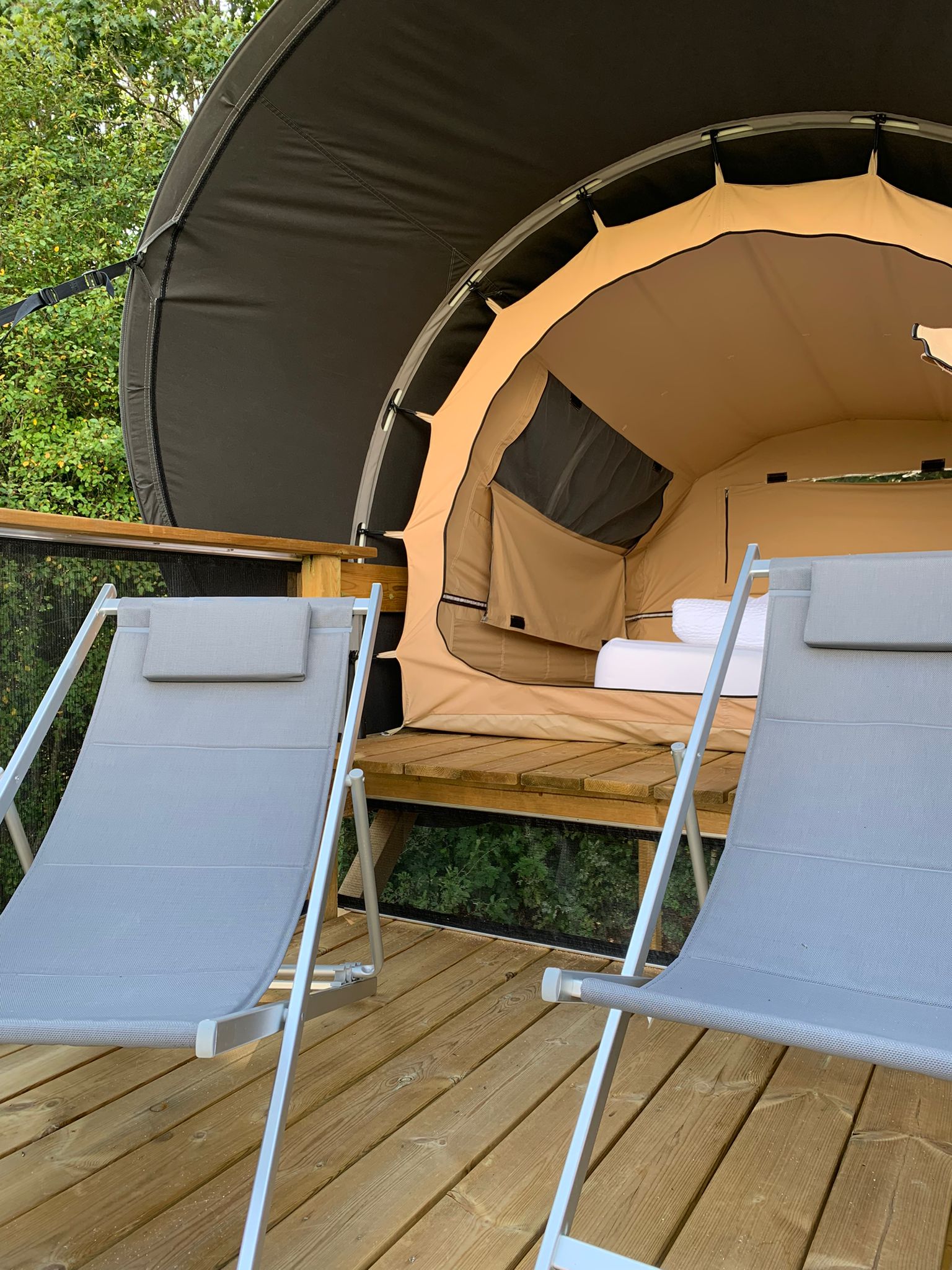 WhatsApp Image 2023-09-21 at 16.42.49 (1) Hébergement insolite en bulle à Limousin, avec chaises longues sur une terrasse en bois.