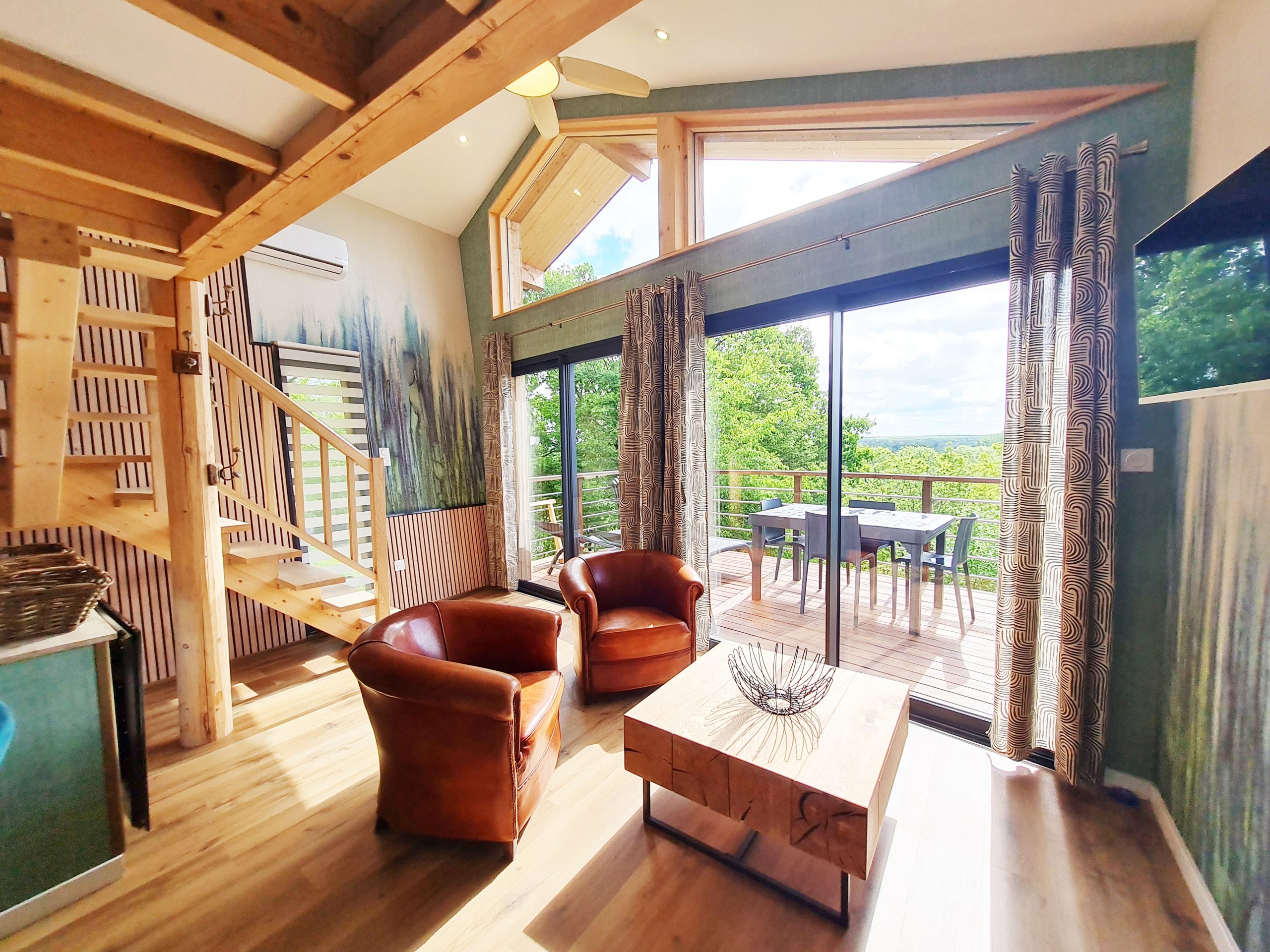 vue-sejour-2 Hébergement insolite en bois avec vue panoramique et salon lumineux à Bourgogne-Franche-Comté.