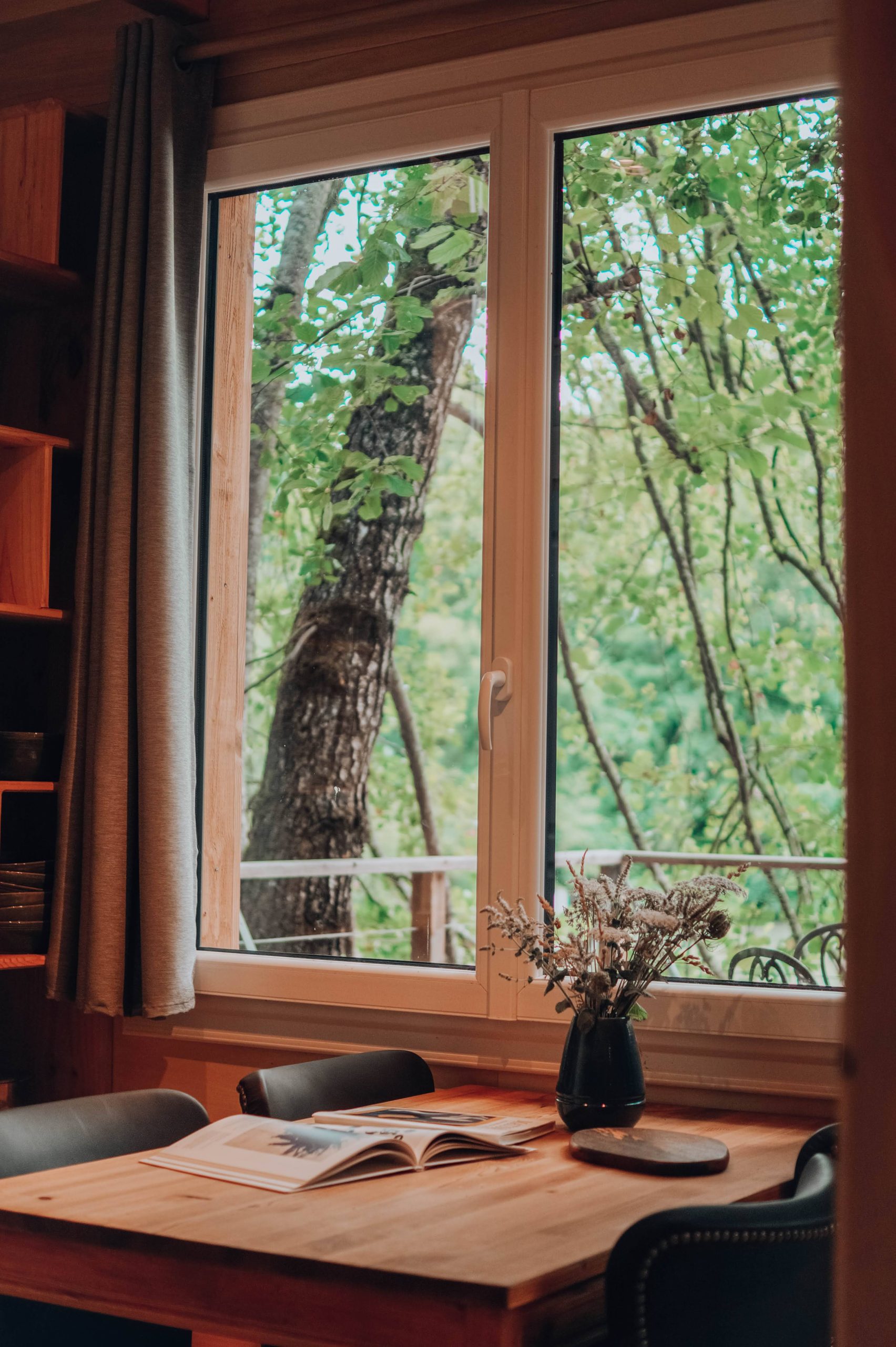 table2 Cabane en bois à Nouvelle-Aquitaine, vue sur la nature verdoyante depuis la fenêtre.